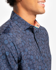 Dark navy blue breathable polo with orange and blue circular all over print and peach inner collar 