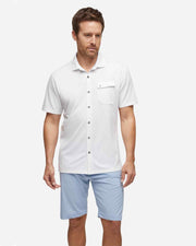 White textured short sleeve button down with asymmetric left chest pocket with button paired with baby blue shorts