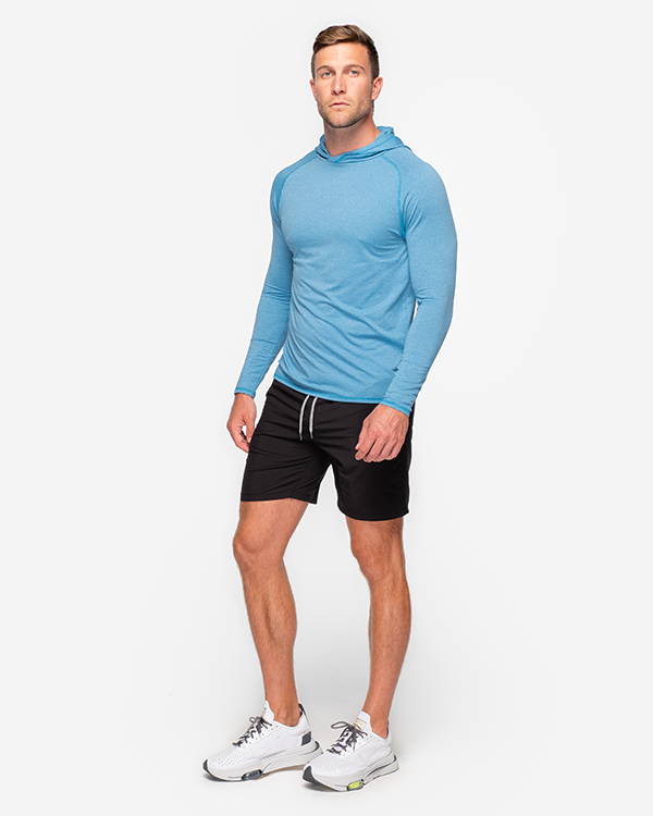 Bright blue llightweight long sleeve performance hoodie paired with black shorts