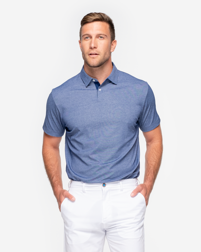 Heathered classic navy blue golf performance polo with dark navy blue collar detail and two button placket paired with white shorts