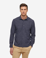 Dark navy blue breathable and stretchy long sleeve button down paired with khaki pants