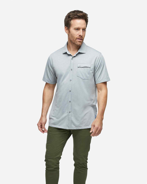 Grey textured short sleeve button down with asymmetric left chest pocket with button paired with army green pants