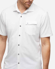 White textured short sleeve button down with asymmetric left chest pocket with button