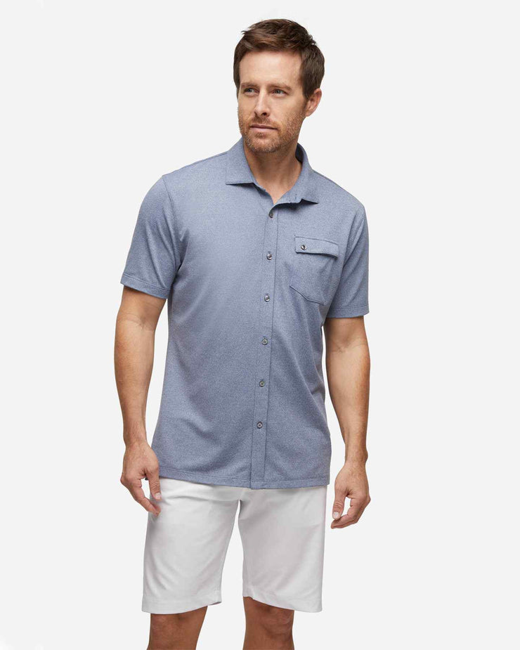 Navy blue textured short sleeve button down with asymmetric left chest pocket with button paired with white shorts